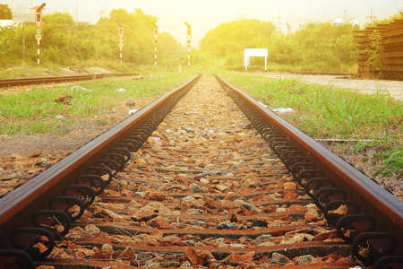 Abstract background of Railroad tracks during sunset with a beautiful golden lightの写真素材