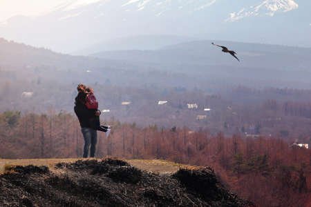 Couple travelers Man and Woman hugging each other happily on the peak of the mountain surrounded by beautiful natural. Travel and happiness Concept.の写真素材