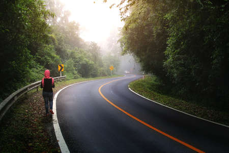 Woman tourists walking on roadside in the rain forest at Doi Inthanon, Chiangmai Province in Thailand. Journey and natural conceptの写真素材