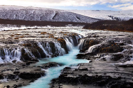 Beautiful scenery of Bruarfoss waterfall at southern Iceland where a series of small runlets of water runs into a beautiful, turquoise-blue colored pool. Travel and natural Concept.の写真素材