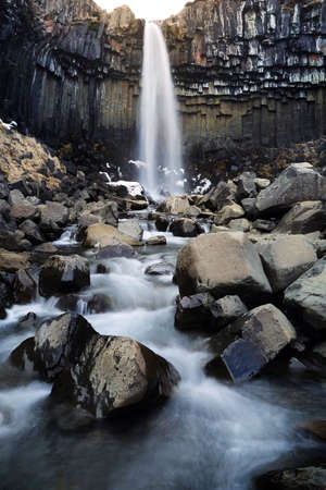 Beautiful scenery of Svartifoss in Iceland. Svartifoss waterfall or Black Waterfall is the famous natural landmark and tourist destination place of Iceland. Travel and natural Concept.の写真素材