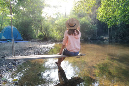 Female tourists sit and rest among beautiful nature park. Relaxation and travel conceptの写真素材