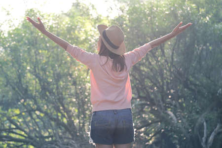 Female traveler relaxing among beautiful nature park. Relaxation and travel conceptの写真素材