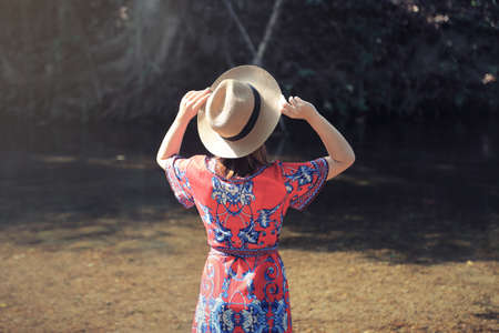 Female traveler relaxing among beautiful nature park. Relaxation and travel conceptの写真素材