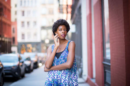 Street portrait of young fashionable African American woman. Photographed in Soho, NYC.