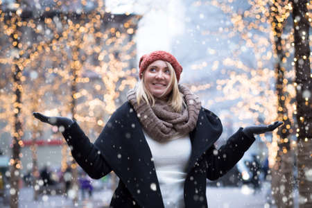 Portrait of young attractive woman with holiday lightsの写真素材