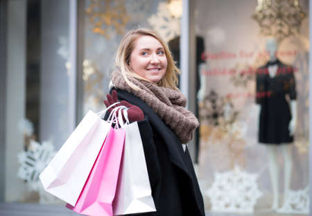 Portrait of young Caucasian woman shopping for Christmas, photographed in NYC in December