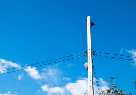 electric pole power lines and wires with blue sky.