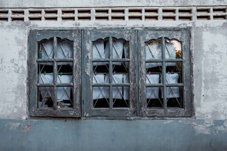 Old abandoned window, detail of a window of a house in ruins, evictions and abandonment, crisisの写真素材