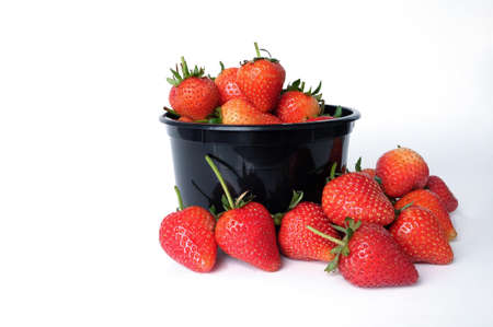 black bowl with strawberries isolated on white backgroundの写真素材