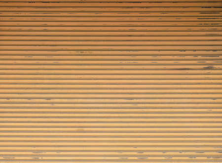 Orange roll gates,old shuttered roll up metal orange doorの写真素材