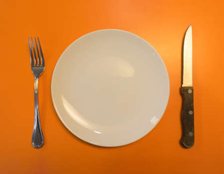 Top view ,Cutlery Set with plate on orange table backgroundの写真素材
