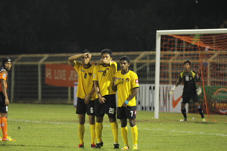 JOHOR BAHRU - JANUARY 14 ; Three Negeri Sembilan football players forming a wall as Johor FC player preparing to take a freekick during a Malaysian Super League match between Johor FC and Negeri Sembilan at JCorp Stadium on JANUARY 14th, 2012 のeditorial素材