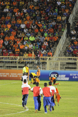 JOHOR BAHRU - JANUARY 14 ; Medic rushing to bring players injured out for treatment during a Malaysian Super League match between Johor FC and Negeri Sembilan at JCorp Stadium in Pasir Gudang on January 14th 2012  のeditorial素材