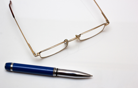 Glasses and pen on whiteの写真素材