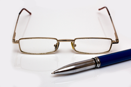 Glasses and pen on whiteの写真素材