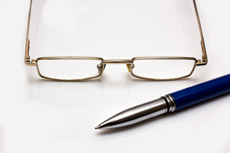Glasses and pen on whiteの写真素材