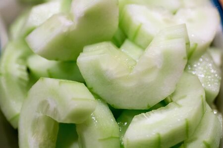 Cucumber slided after chopping in small pieces.の写真素材