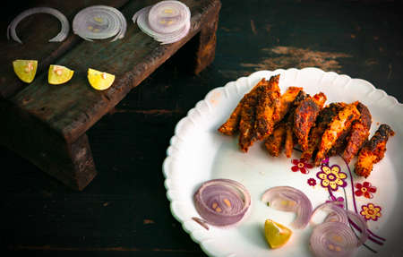 Healthy tasty and spicy fish fry kept on a white plate ready to be servedの写真素材