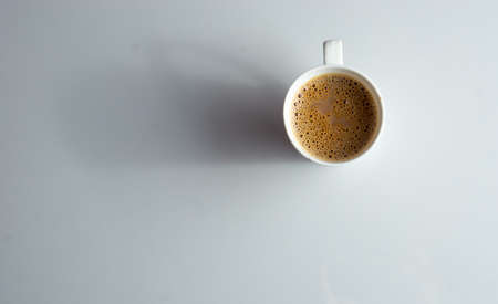 A cup of tea with lot of work space in the side on a white backgroundの写真素材