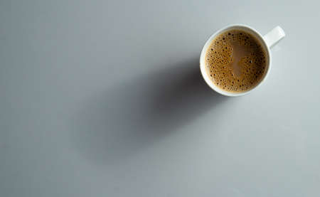 A cup of tea with lot of work space in the side on a white backgroundの写真素材