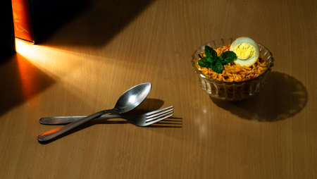 Tasty homemade egg biriyani in a bowl on the wooden tableの写真素材