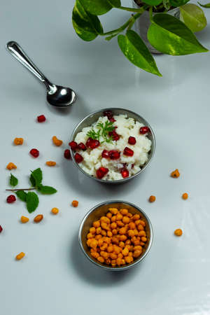 Homemade delicious and tasty curd rice with mixture on a white backgroundの写真素材