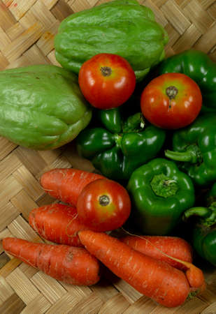 Fresh and uncooked raw vegetables stacked in a bamboo Panの写真素材