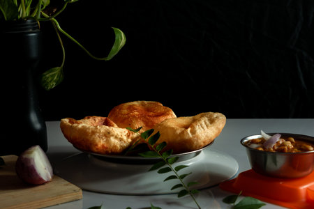 Delicious and tasty Homemade poori placed on a plate with black and white background with selective focusの写真素材