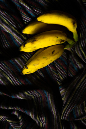A bunch of vitamin rich fresh Yellow banana with selective lightingの写真素材