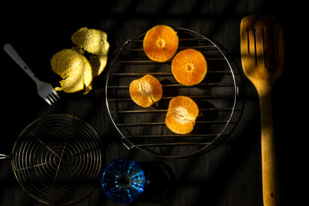Healthy and fresh colorful oranges pealed off and kept on the table with artistic lighting