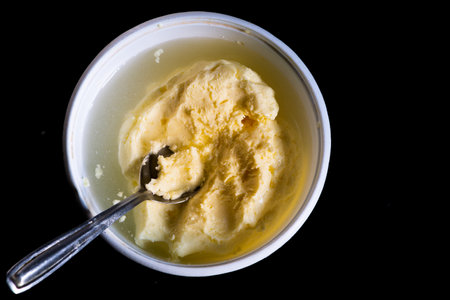Fresh homemade healthy butter in a bowl with a spoon on itの写真素材