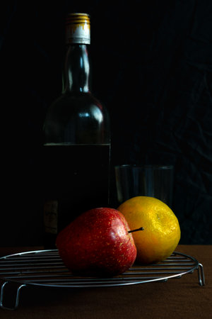 An apple and moosambi fruit placed on a brown backgroundの写真素材