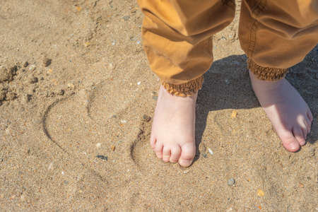bare children's feet on the beach. children's feet close-up