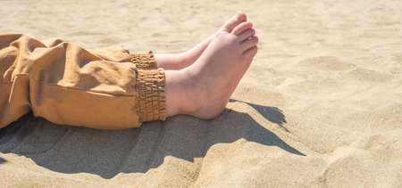 bare children's feet on the beach. children's feet close-up