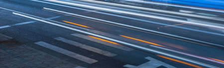 pedestrian crossing at night in the blue light. pedestrian lanes on wet asphalt in neon lights....