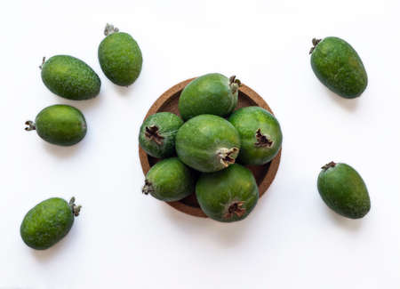 Green feijoa fruits in a cork plate isolated on a white background. Tropical fruit feijoa. Set of ripe feijoa fruits. the view from the top. Copy spaceの写真素材