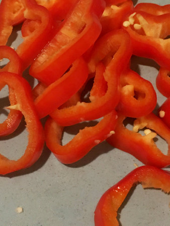 sliced red bell pepper lies on the board, close-up