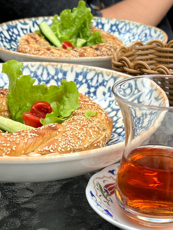 Traditional Turkish bagel simit, breakfast, on a white table, rustic, no people