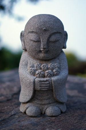 Japanese garden in Krasnodar Park. KRASNODAR, RUSSIA - JUNE 7, 2025: small stone sculpture of Buddhaのeditorial素材