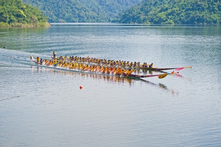 NAYOK, THAILAND - DECEMBER 3  A pair of unidentified traditional Thai long boats with a crew of 50 compete Chakri Sirindhorn Cup, a champion long boat race, on December 3, 2011 in Nayok, Thailand  のeditorial素材