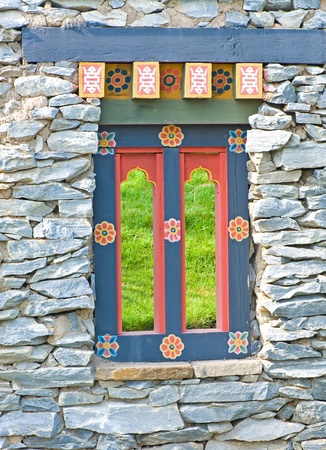 Bhutanese window in the stone wall の写真素材
