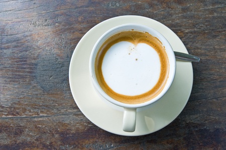Latte coffee on wooden table の写真素材