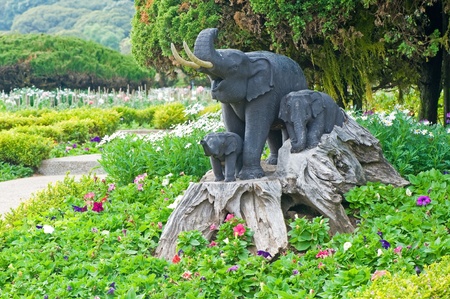 Elephant statue in flower garden の写真素材