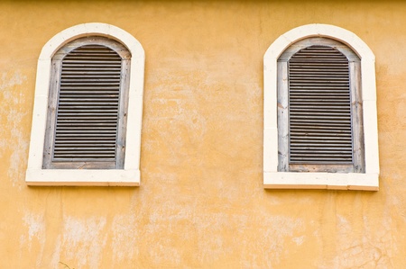 Vintage window on yellow cement wall can be used for backgroundの写真素材