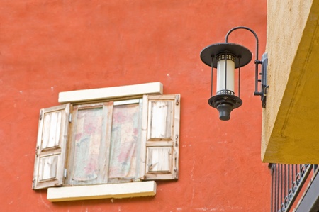 Lamp and Vintage window on orange cement wall can be used for backgroundの写真素材