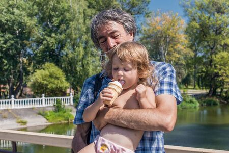 The family father and daughter outdoors. The concept of happiness, prosperity.の写真素材