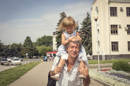 The family father and daughter outdoors. The concept of happiness, prosperity.の写真素材