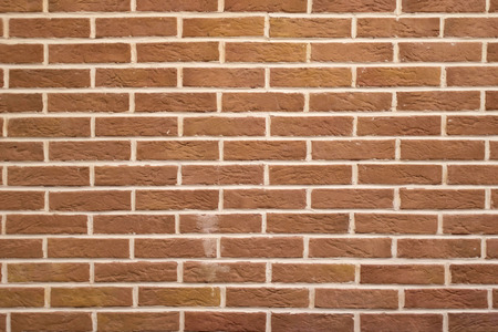 High resolution texture of a red brick wall background in the countryside, blocks of stone, brick masonry horizontal color technology architecture wallpaper.の写真素材