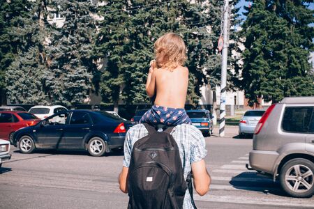 Happy father and daughter together, concept of children and people. Father and daughter on shoulders.の写真素材
